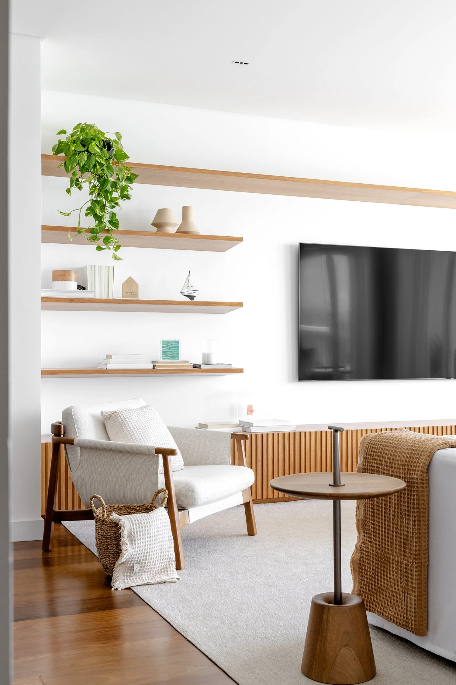 Living com painel de TV e prateleiras suspensas — Apartamento GM, VK Arquitetos