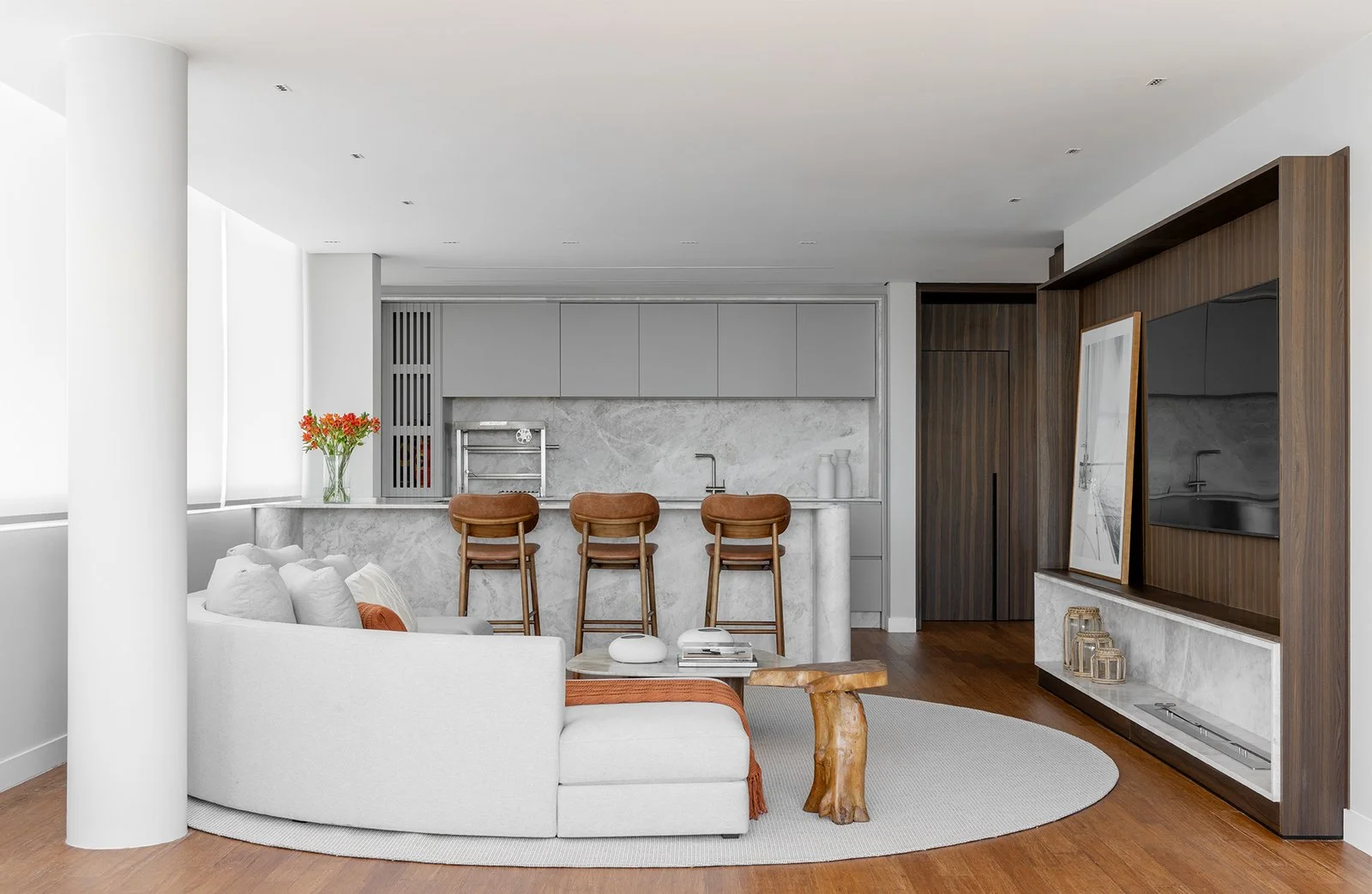 Cozinha com bancada curva e living ao fundo — Cobertura Bleu, VK Arquitetos